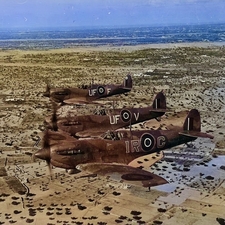 Spitfire formation flying over North African desert 